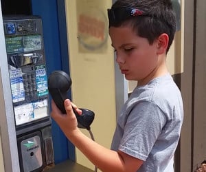 Kid Baffled by Payphone