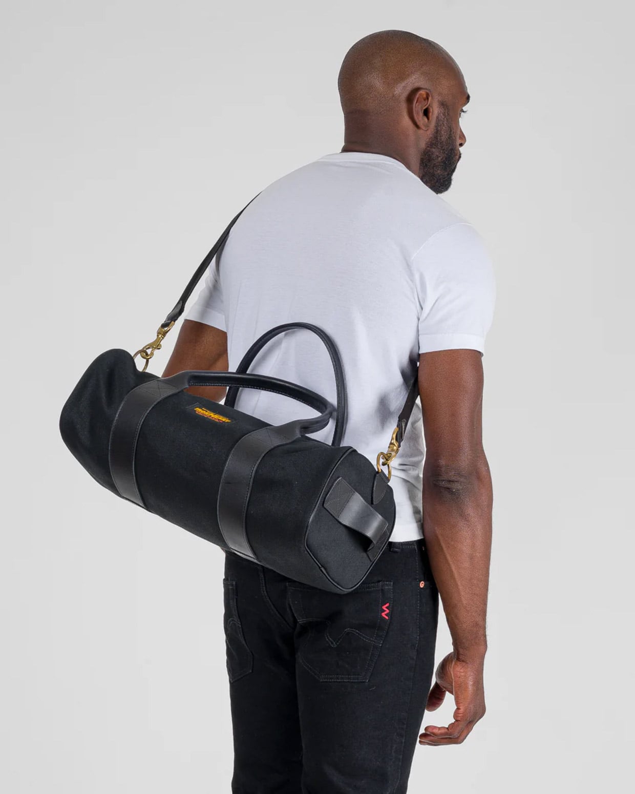 This Rugged Japanese Duffel bag Pairs Black Denim with Italian Leather